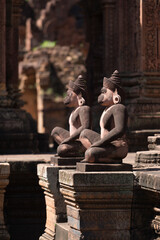 Selective focusing on the pink sandstone guardian statue carvings of Banteay Srei or Banteay Srey or The pink sandstone, Siem Reap, Cambodia.