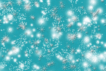 white bokeh and flakes on a blue background. blue and white blur, used as wallpaper. Christmas background for design.