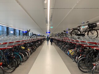 Modern two levels indoor bicycles storage next to the Tilburg train station. Tilburg, North Brabant / Netherlands 

