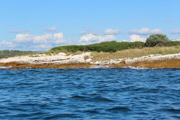 Blue sea and sky with rocky island