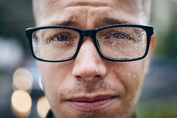 Man with eyeglasses in rain