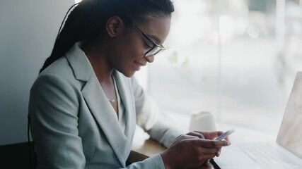 Happy smart casual businesswoman using smartphone in the cafe. Beautiful positive young business lady browsing internet checking social media smiling. Customer. Formal concept. - Powered by Adobe