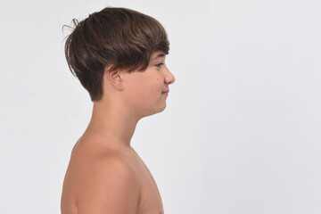portrait of a shirtless teen boy on white background, profile