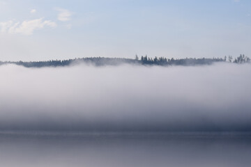 Fog over a lake in the morning in Lipno Nad Vltavou, Czech Republic