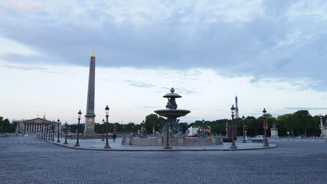 Plave de la concorde with fountain and luxor obelisk with fery few trafic and cars during early morning in Paris, arc wide shot