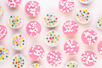 Colorful cupcakes on a white background.