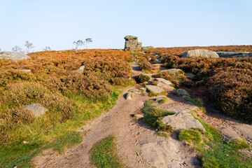 Fototapeta na wymiar Up a rugged path to Mother Cap on misty autumn Derbyshire morning