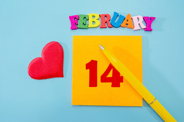 February 14 - from colored letters, sticker, pen and red heart, important date concept, blue background.
