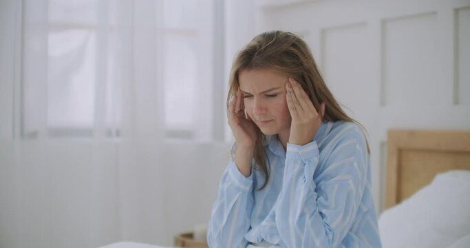 Woman holding head. Woman having head pain at home. Woman having headache. My head feels like it is going to explode
