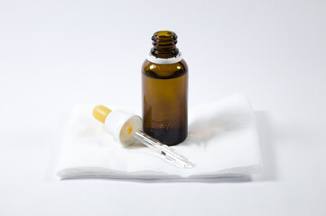 Dropper with glass ampoule and white and gray background