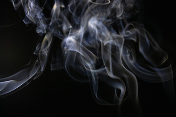 White flowing smoke on black background