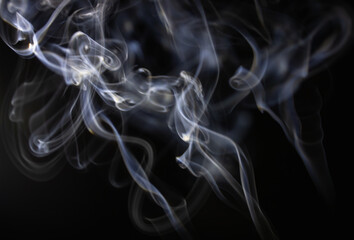 White flowing smoke on black background