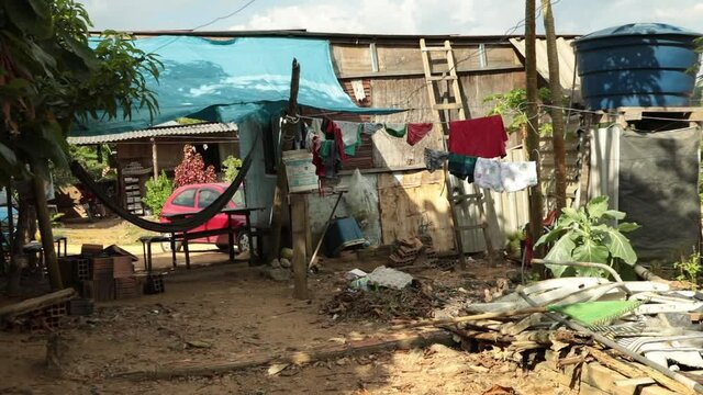 Shack house in an impoverished slum outside of Manaus, Brazil. Establishing shot. 