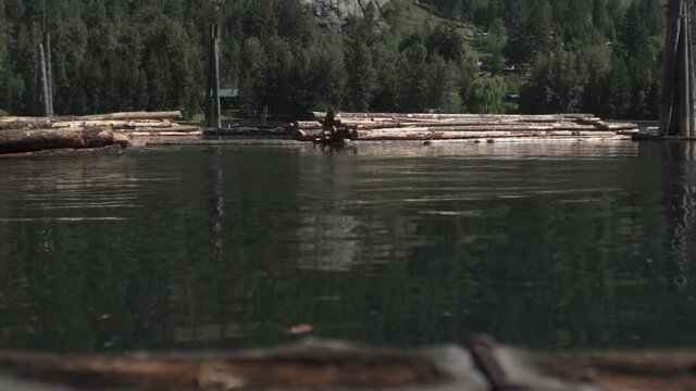 Tugboat Pushes Logs Along River Left to Right