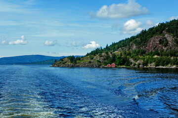 Scenic views of cottages in the woods on the shores of Osterfjord near Bergen, Norway