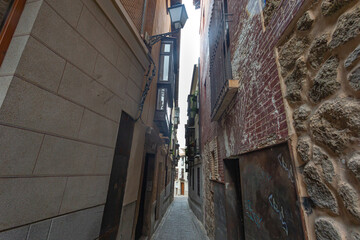 Narrow and old streets with stone and mud buildings in the city of Toledo
