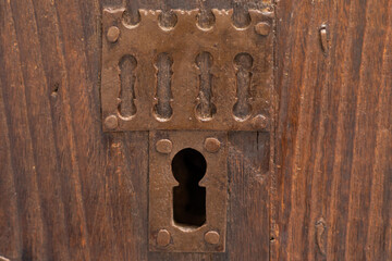 Old doors with wrought iron door knockers and bolts in the city of Toledo