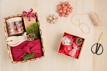 Preparing care package, sasonal gift box with kitchen utensils, furoshiki box and cookies