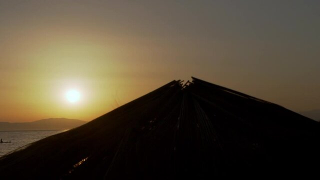 Sunset at Kalamata with silhouettes of beach umbrellas in the foreground  120fps