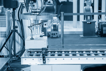 The hi-technology  material handling process by robotic system. The automatic pneumatic robotic arm picking the container box in production line.