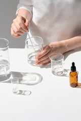 The scientist, dermatologist testing the organic natural cosmetic product in the laboratory. Vials, glass laboratory flasks. Beauty cosmetic research and development concept. © Vita Monart