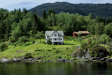 Fototapeta na wymiar Scenic views of cottages in the woods on the shores of Osterfjord near Bergen, Norway