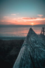 sunset at the beach with a wooden foreground texture background