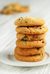 Freshly baked homemade Christmas cookies with cranberries, almonds and white chocolate close-up. Delicious festive biscuit. Gingerbreads. Selective focus