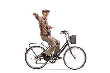 Happy elderly man riding a bicycle and spreading arms