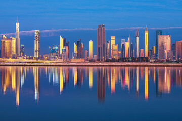 Dubai skyline with reflection in the river at sunrise , Dubai, United Arab Emirates 