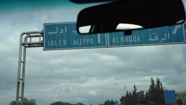 Driving Under Aleppo Direction, Road Sign on Deserted Syrian Highway Slow Motion