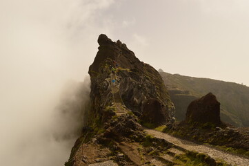 Climbing to the dramatic peak of Pico Ruivo mountain on the ridge of Madeira Island, Portugal