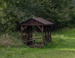 Fototapeta na wymiar Wooden shelter on green pasture land near Osadne village