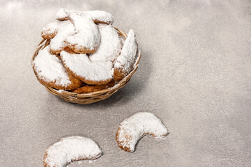 Traditional Austrian and German crescent-shaped Christmas pastries - Vanillekipferl - on a gray table