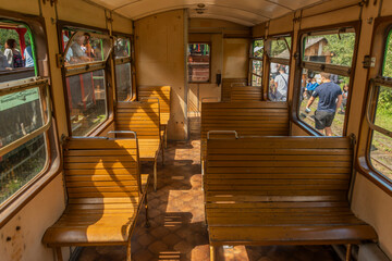 Interior of old wooden coach on narrow gauge railway in Balnica station - obrazy, fototapety, plakaty
