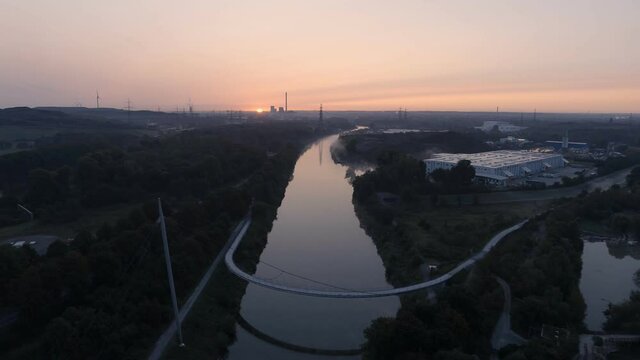 Sunrise over Grimberger Sichel Pedestrian Bridge on Rhine-Herne Canal in Germany, Aerial Drone View
