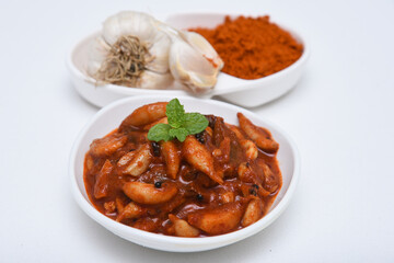 Home made sour hot and spicy garlic or Lehsun pickle,  Kerala South India made using red chilli and Indian spices. Its cloves are used for consumption raw or cooked or for medicinal purposes