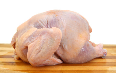 Raw chicken on wooden board