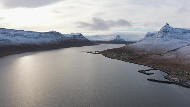 Panning across Magnificent Snow Covered Mountains Surrounding Large River The Westfjords, Drone Aerial