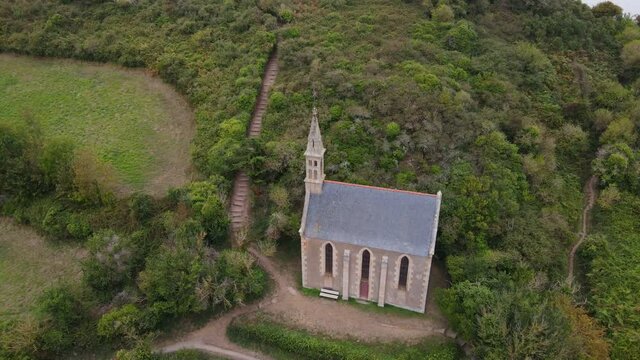 Circular fly around the Trinity point Chapel near Paimpol, Brittany, France
