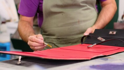 Italian shoemaker, making leather bag with traditional machines.

Location: South Tyrol, Italy