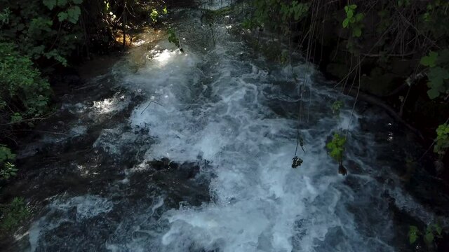 Strong flow of fresh water at the Banias river, at the Golan heights, Israel. Slow motion shot.