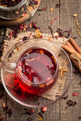 Cup of fresh red tea on wooden background