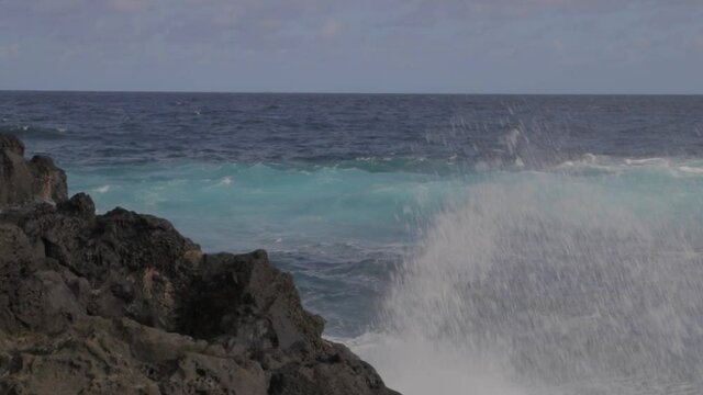 A big wave crashing into rocks in the Indian Ocean, île de la Réunion, France