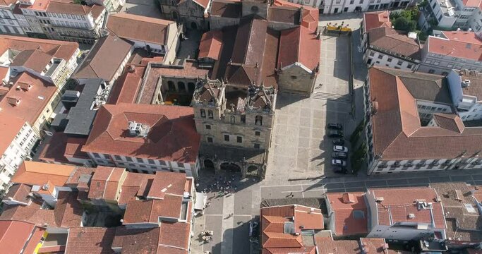 People In Front Of The Braga Cathedral (Se De Braga) In Braga, Portugal On A Sunny Day - aerial drone