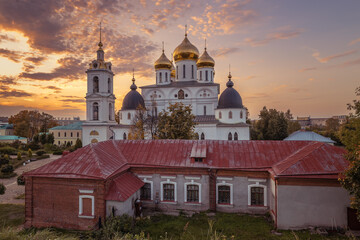 Fototapeta na wymiar Assumption Cathedral in Dmitrov Kremlin. Dmitrov Kremlin at sunset. Sign on the building Â«DmitrovÂ»