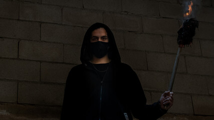 YOUNG MAN WITH FIRE TORCH IN URBAN EXPLORATION URBEX