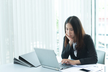 Asian businesswoman stress from hard work,Thai worker woman working in the office,Dark tone