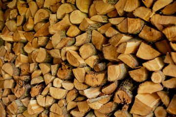 Side view of stack of firewood. Stacked Logs Texture, Natural Background. chopped wood stack for...