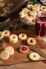 Filling traditional Linzer Christmas cookies with jam
